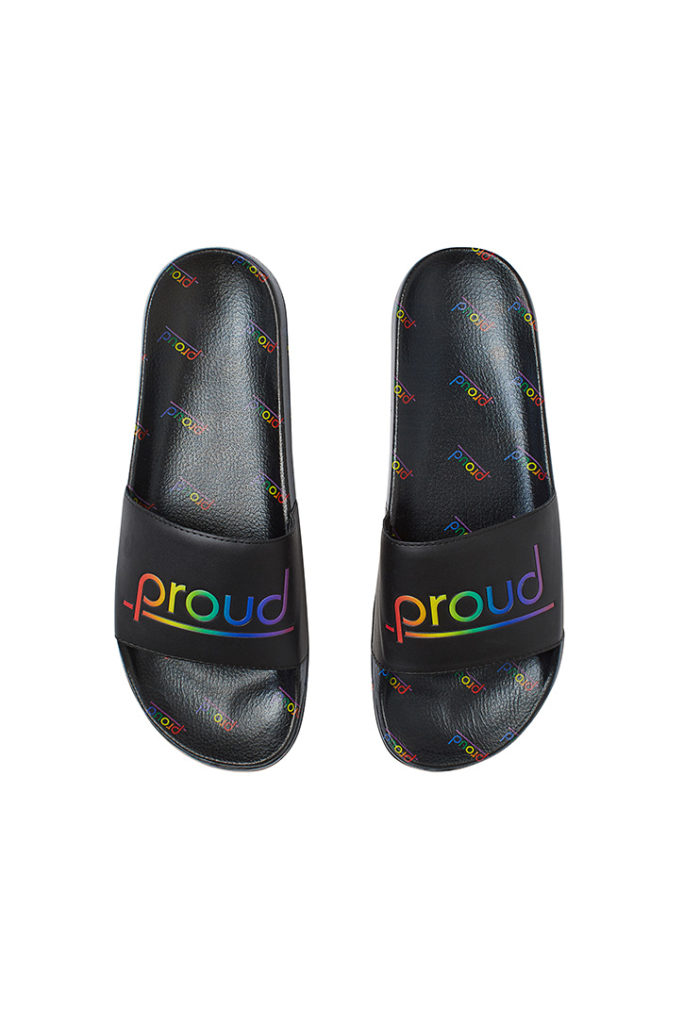 Black sliders with "proud" slogan in rainbow color is part of H&M Unveils Love For All Collection