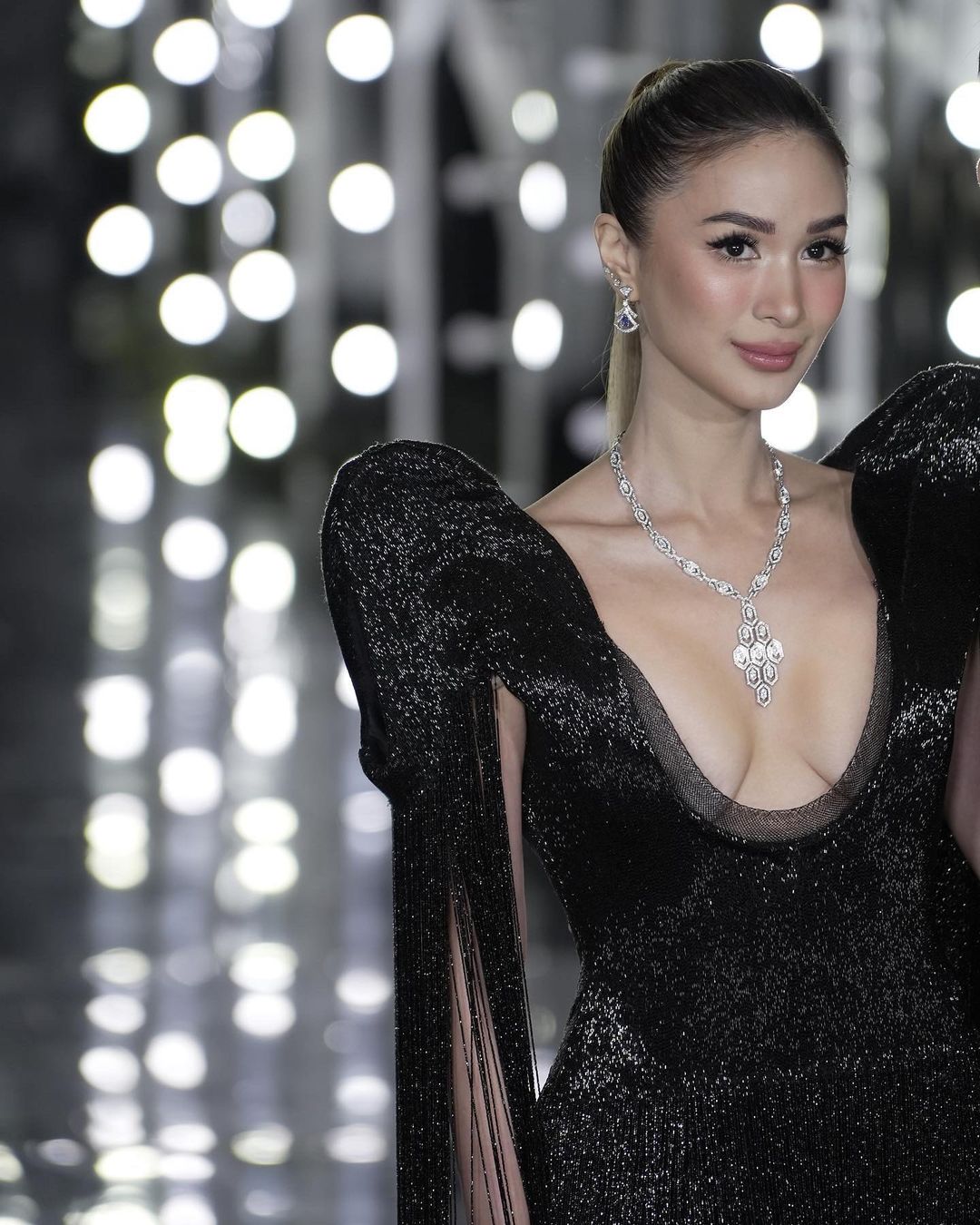 Heart Evangelista black gown with dramatic puff sleeves and long fringes that cascaded down her arms and back.