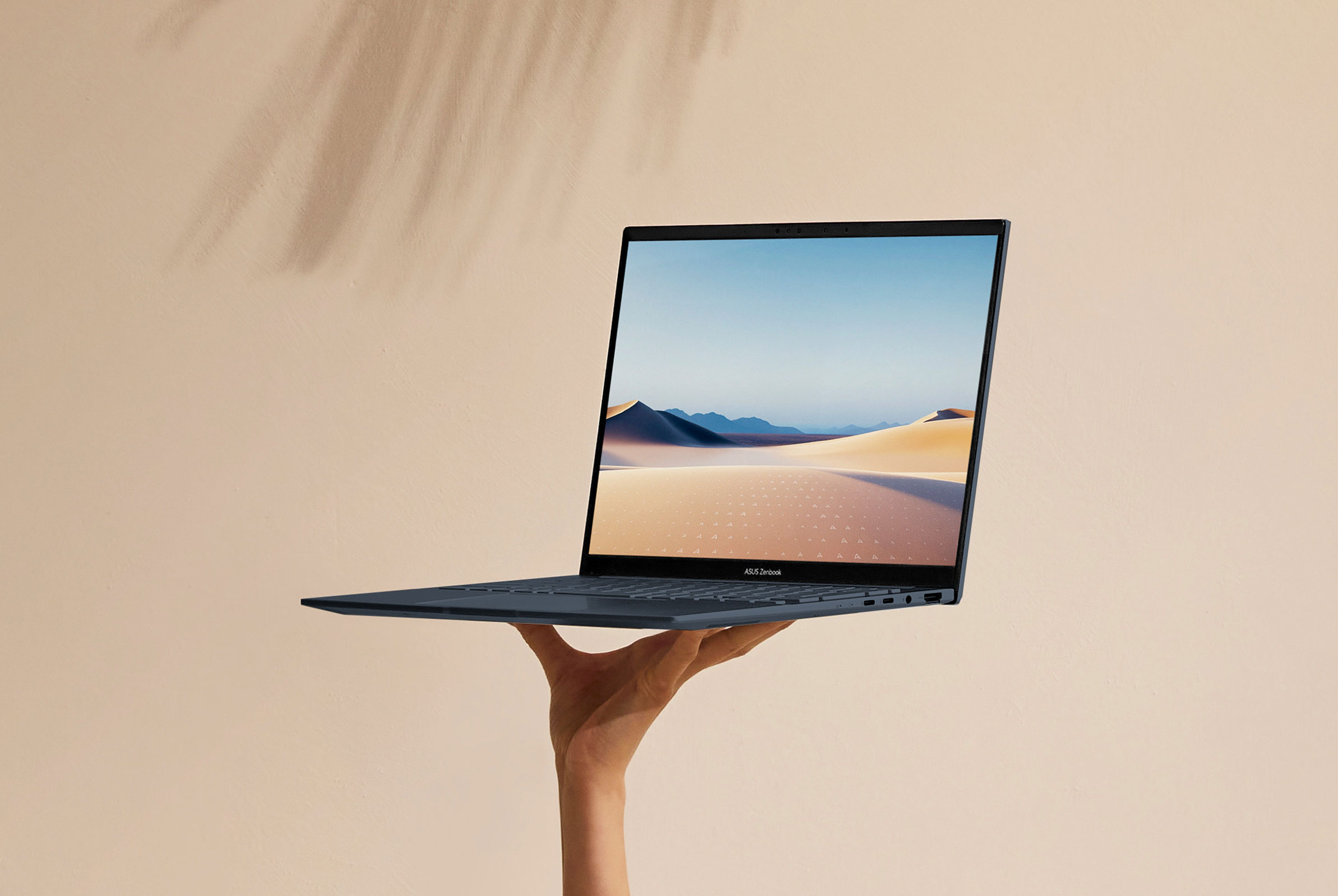 A hand showing that they're holding the ASUS Zenbook 14 OLED