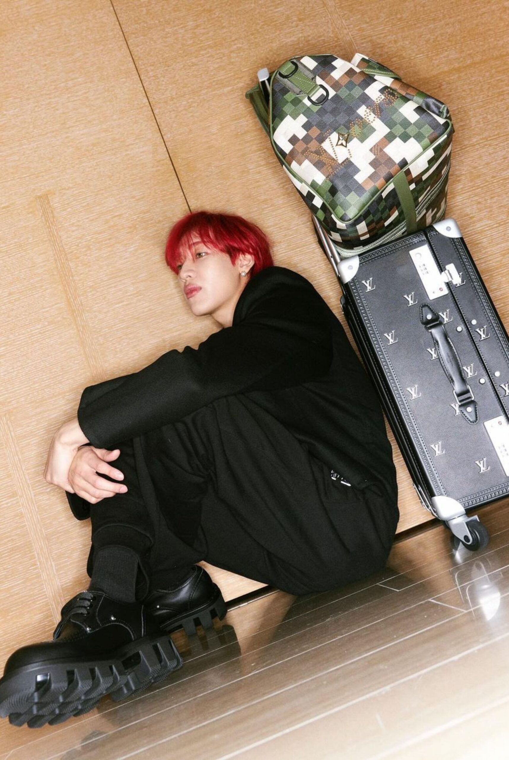 BamBam strikes a pose with the LV Trail Keepall 55 and Rolling Trunk