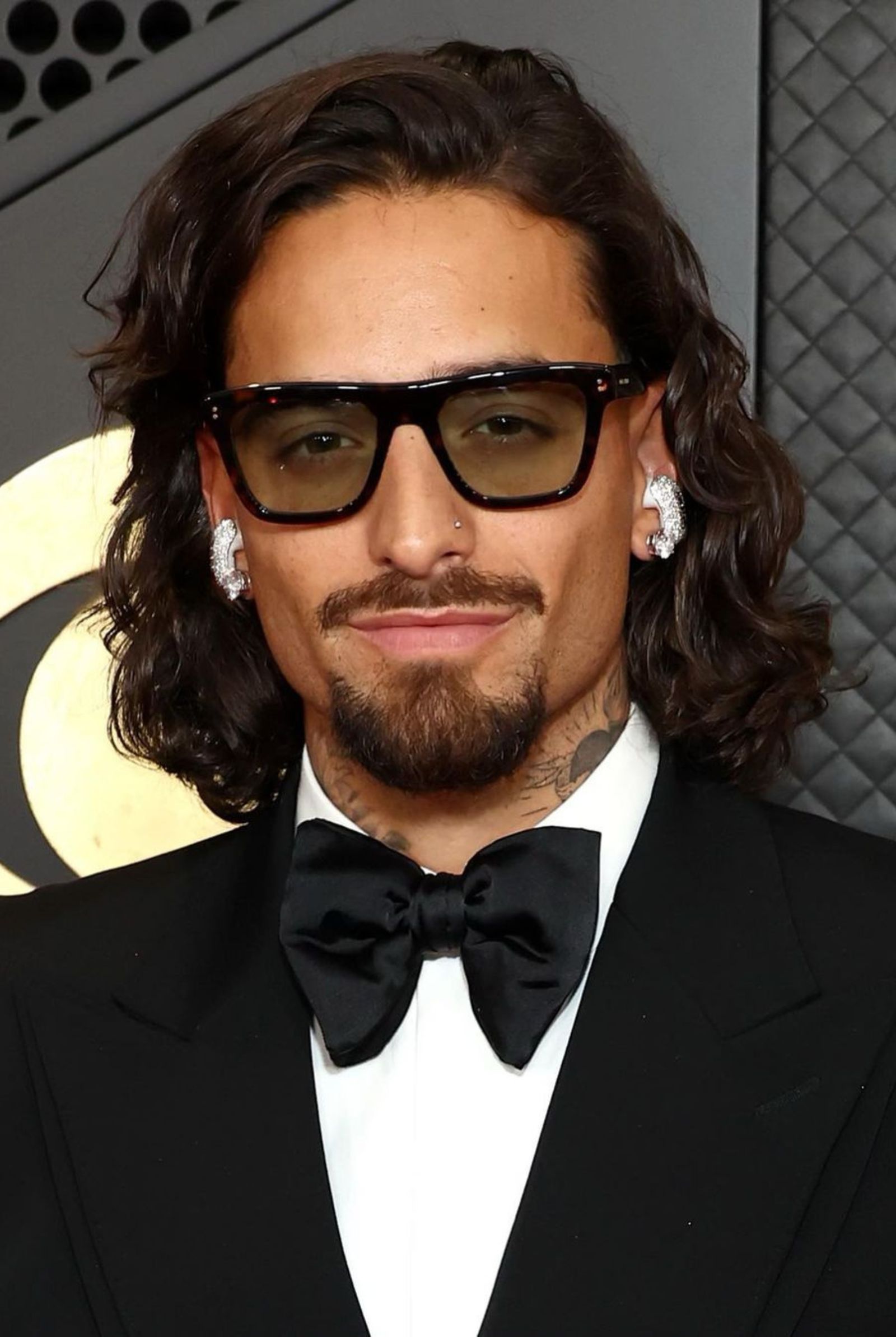 Maluma's red carpet appearance is a glittering affair at the Grammys 2024, featuring bedazzled Bose Ultra Open Earbuds by Atlanta's Icebox