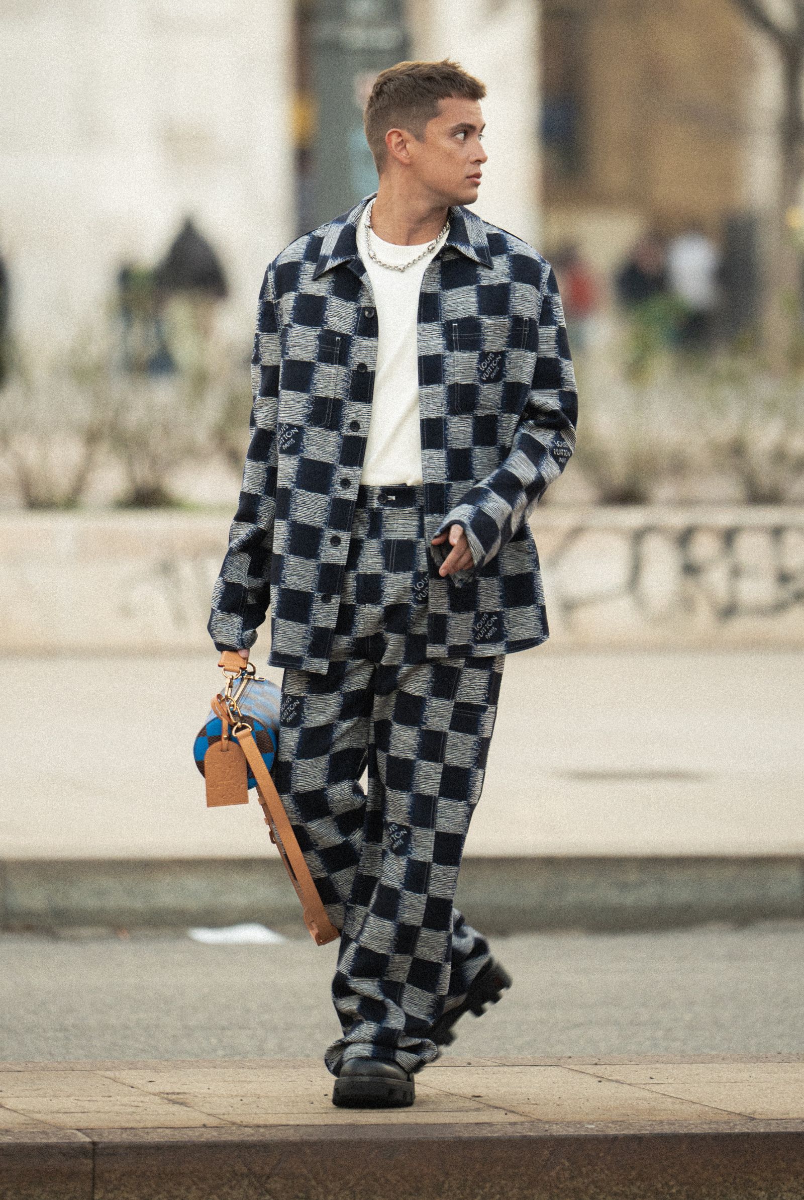 Embracing the charm of the House's Damier pattern, the actor heads to PFW.