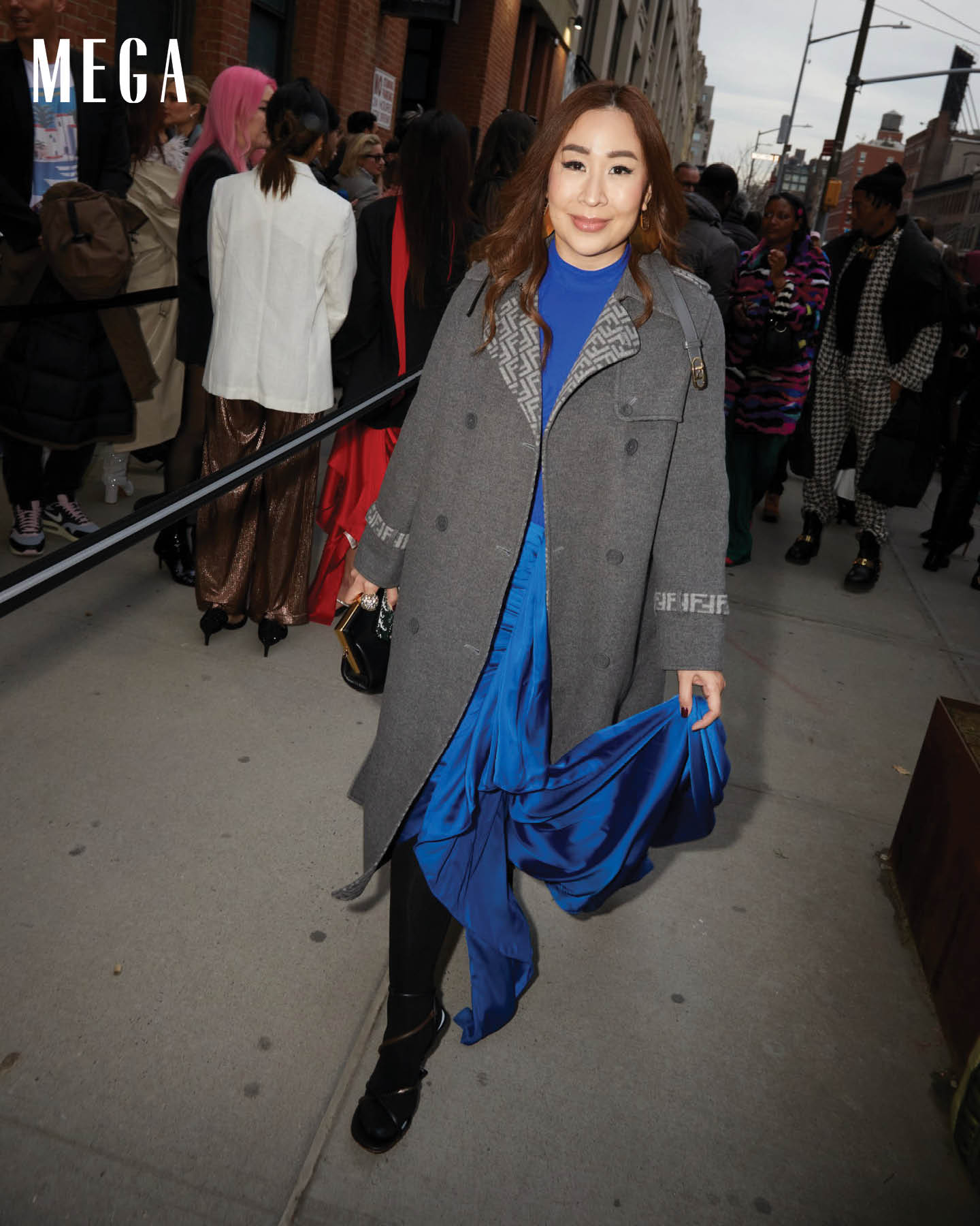 The MEGA Beauty Director stuns in an electric blue dress by MARTIN BAUTISTA and a grey coat by FENDI