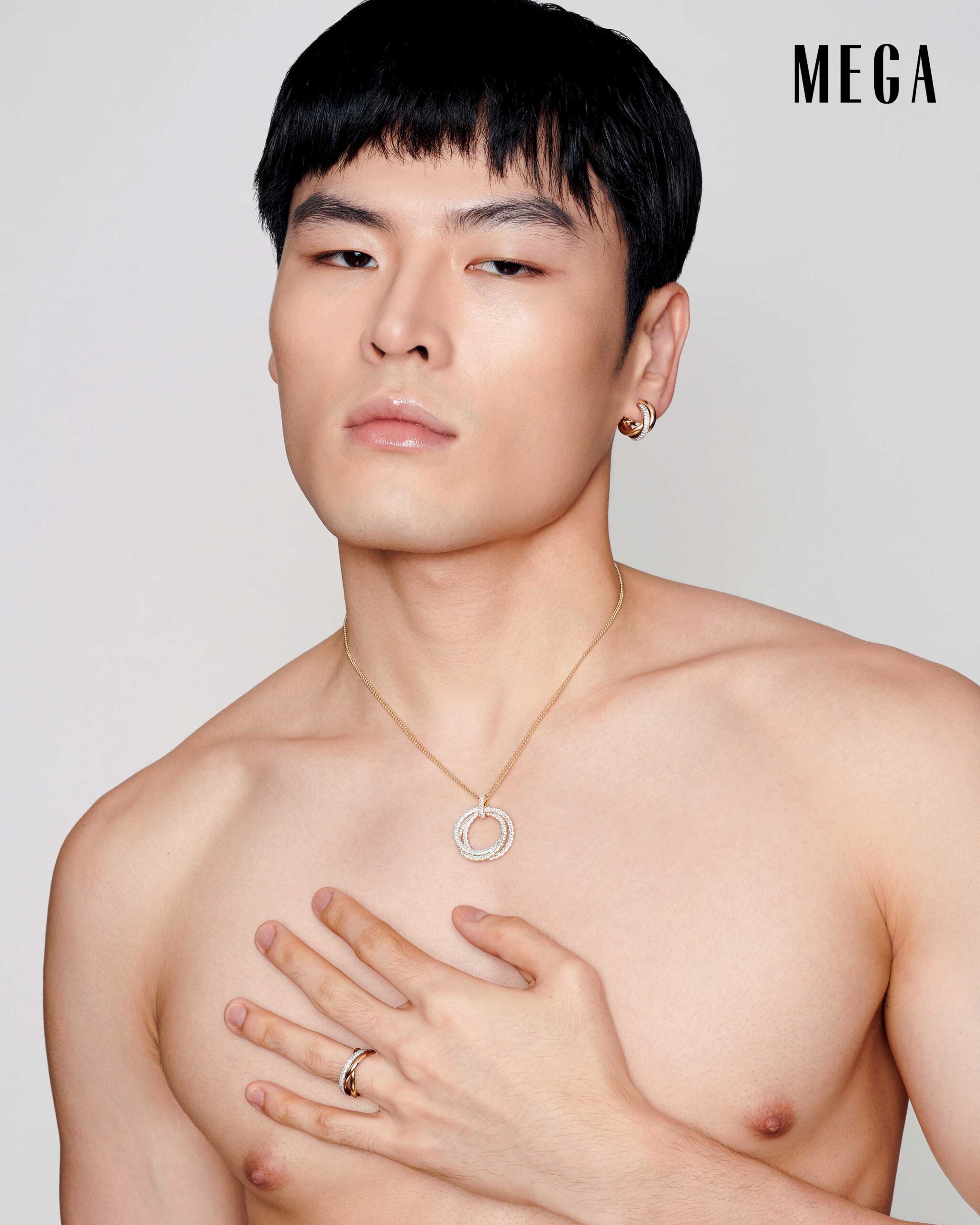 Craig Uy is wearing a CARTIER earring, neckalce, and ring