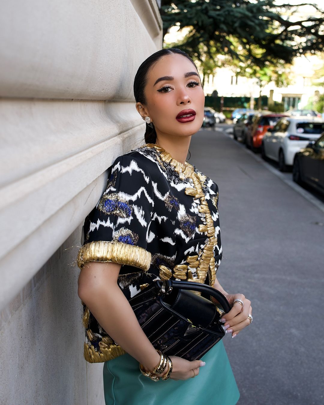 Heart Evangelista donned a gold-trimmed bolero, a gray top, a teal skirt and a Capucine bag for Louis Vuitton's show